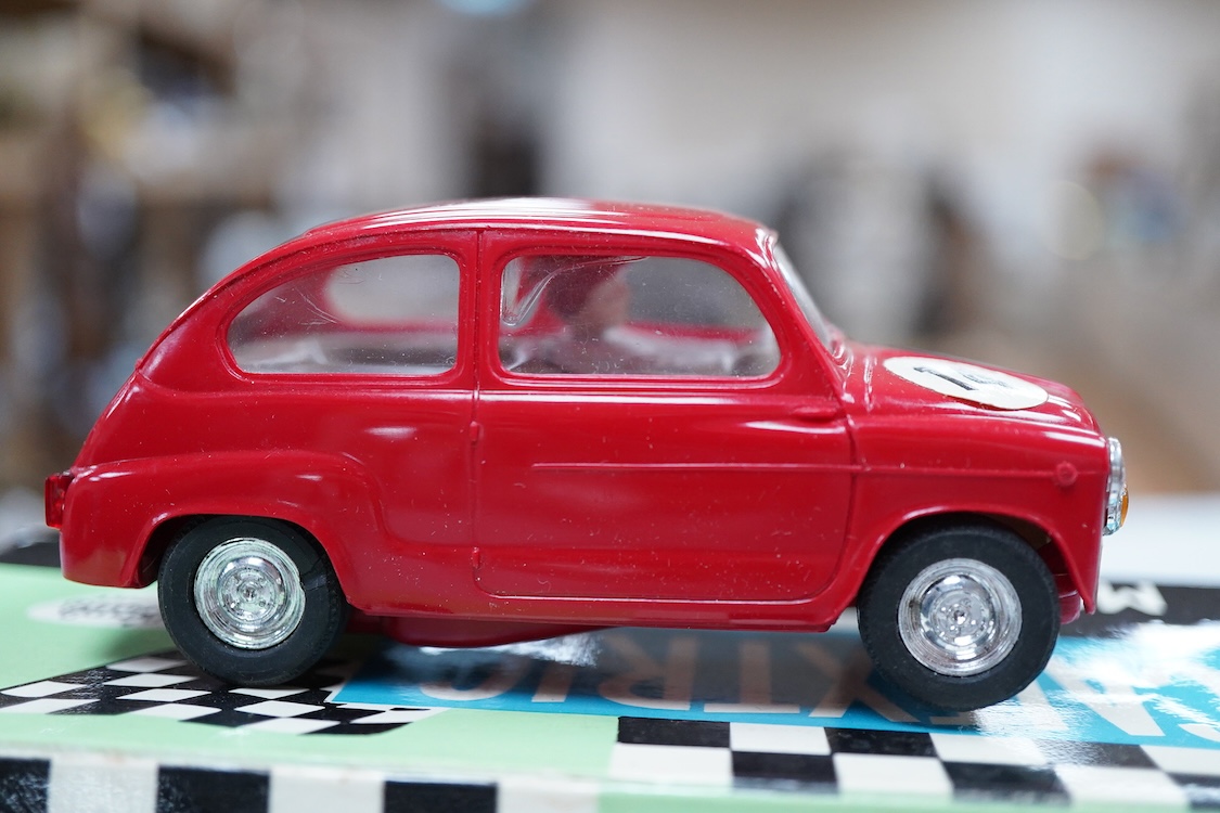 A boxed Tri-ang Scalextric T. C. Seat 600 (C-31) in red, with correct red spot box, together with an unboxed Hurricane combination motorcycle and sidecar MM/82